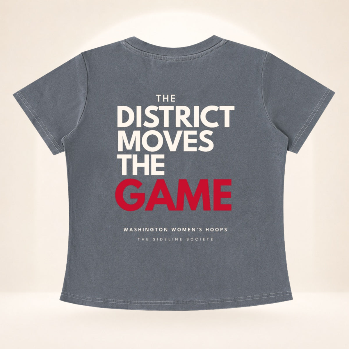 Flat back view of District Tipoff Club vintage wash women's basketball tee with The District Moves the Game graphic.