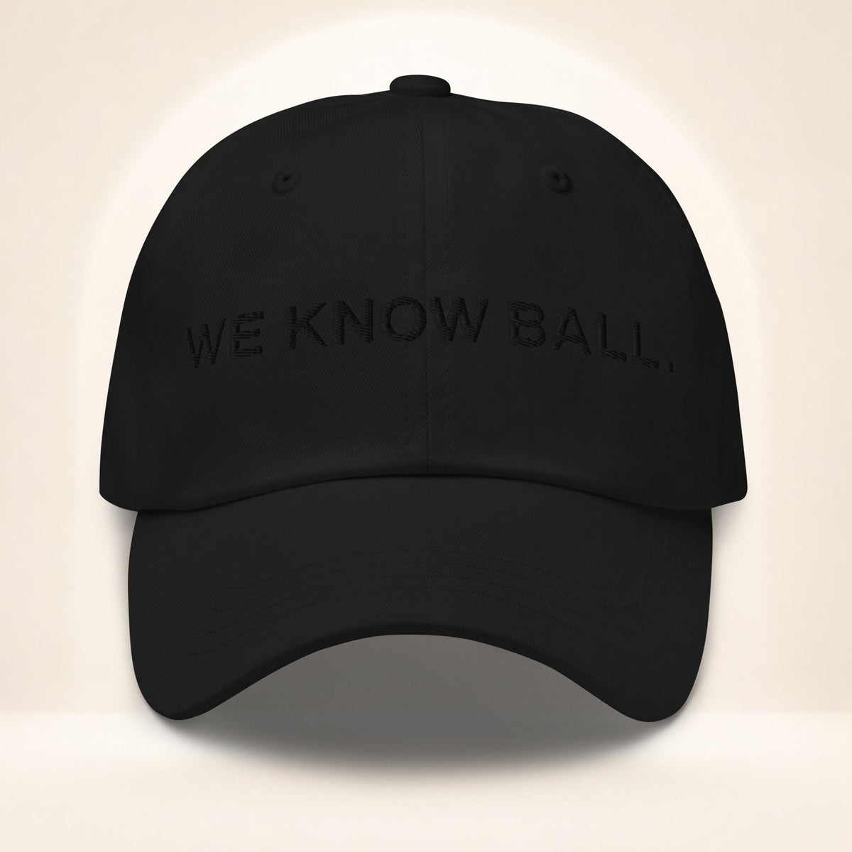 Front view of the black We Know Ball dad hat with tonal black 3D puff embroidery