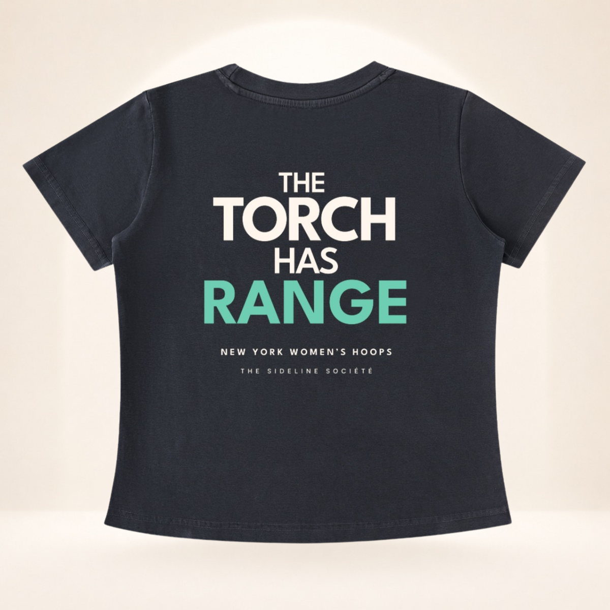 Flat back view of Empire Tipoff Club vintage wash women's basketball tee with The Torch Has Range graphic.