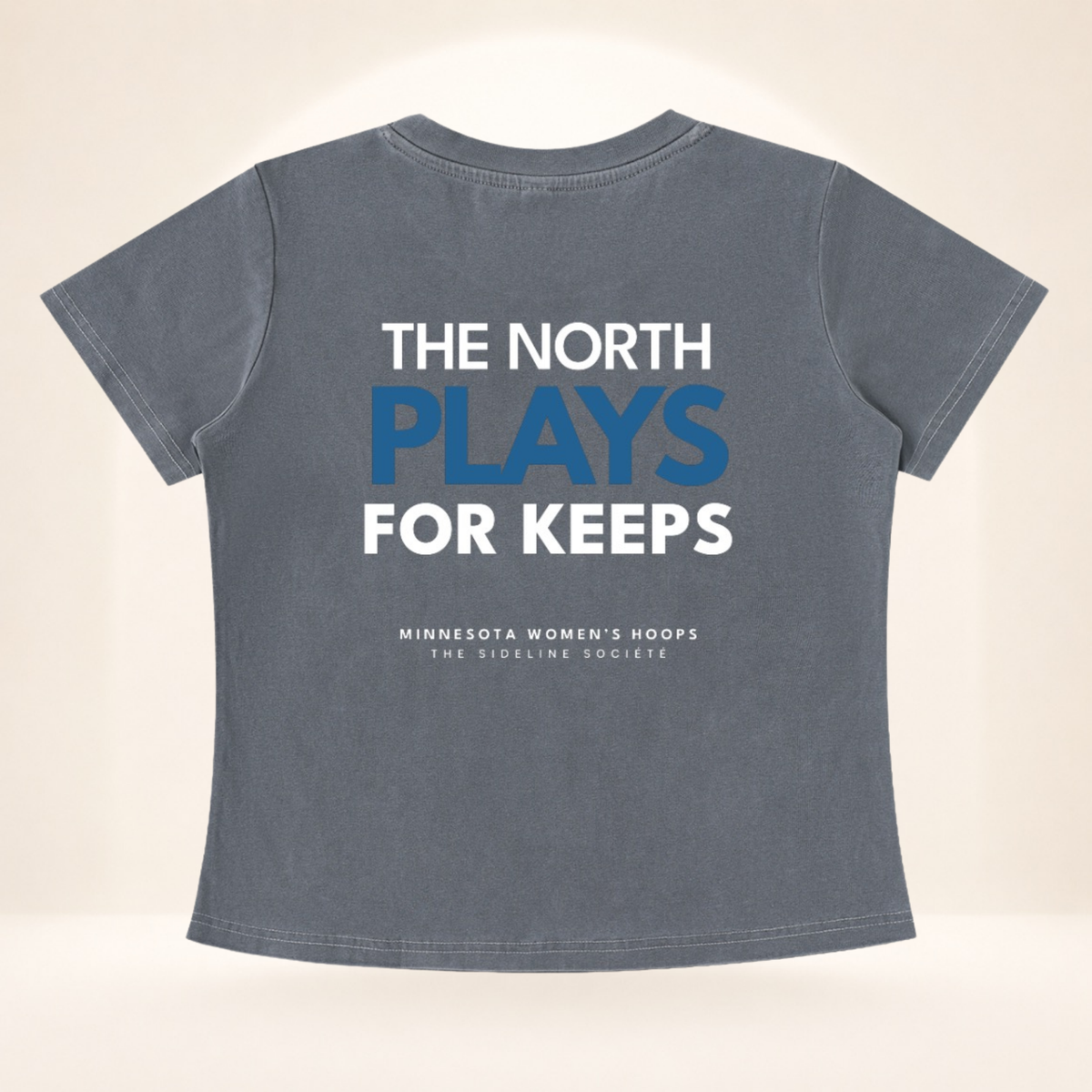 Flat back view of North Star Tipoff Club vintage wash women's basketball tee with The North Plays for Keeps graphic.