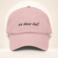 Front view of the We Know Ball Script Dusty Rose garment-washed baseball cap