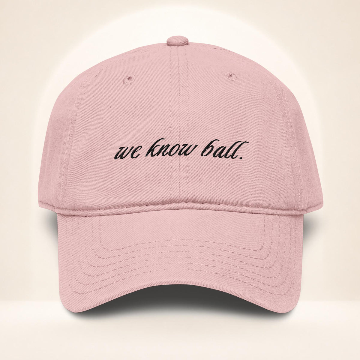 Front view of the We Know Ball Script Dusty Rose garment-washed baseball cap