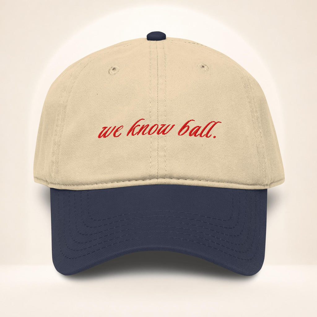 Front view of the We Know Ball Heritage two-tone Navy and Khaki garment-washed baseball cap with red script embroidery