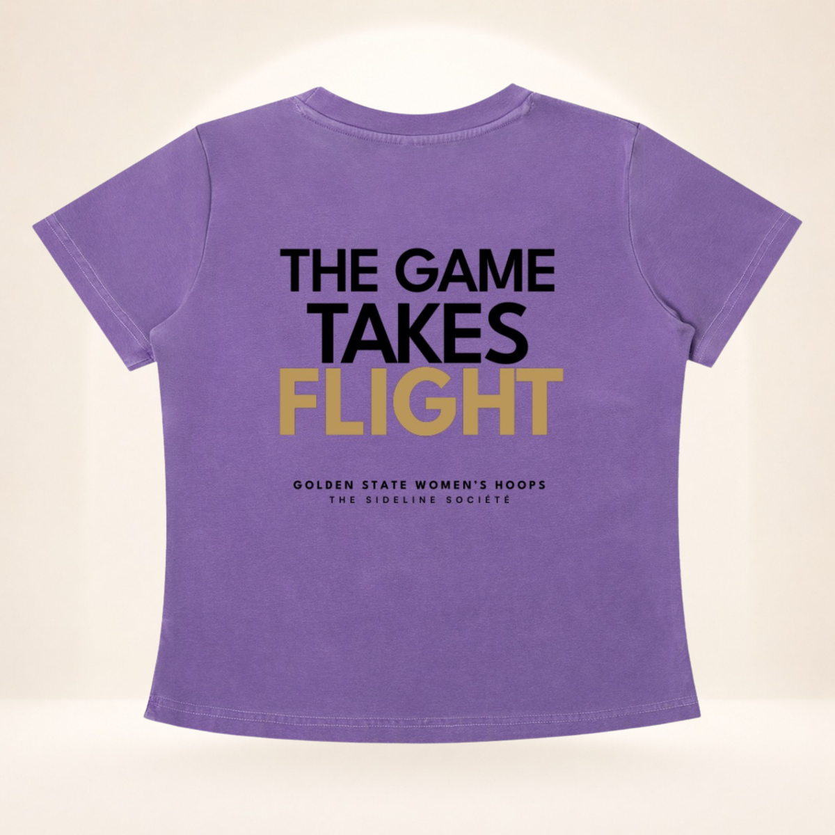 Flat back view of The Bay Tipoff Club vintage wash women's basketball tee with The Game Takes Flight graphic.