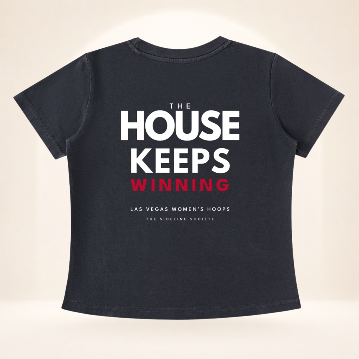 Flat back view of Vegas Tipoff Club vintage wash women's basketball tee with The House Keeps Winning graphic.